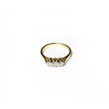 An 18 carat gold diamond three stone ring, the round brilliant cut diamonds in white claw