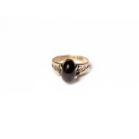 A garnet ring, stamped '10CT', finger size M. Large chip to the garnet. Gross weight 3.4 grams.