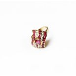 A synthetic ruby and diamond ring, a pear cut synthetic ruby set above five rows of alternating