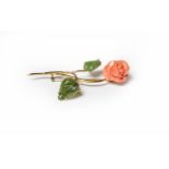 A coral and nephrite floral spray brooch, stamped '750', length 7.5cm . Gross weight 9.1 grams.