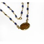 A sapphire, diamond and blue bead necklace with a hammered coin centrally, length 50cm . Gross