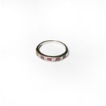 An 18 carat white gold ruby and diamond half hoop ring, finger size L1/2. Gross weight 2.0 grams.