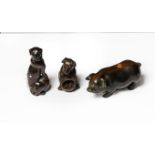 Two Japanese carved wooden netsukes in the form of dogs (both signed) and another of a pig