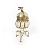 A Brass Mounted Shell Trinket Box, on three scroll feet, the hinged openwork cover with bird finial,