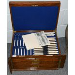 A Goldsmith's & Silversmith's Company Ltd oak cased three drawer canteen containing a complete