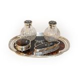 A silver and tortoiseshell dressing table set