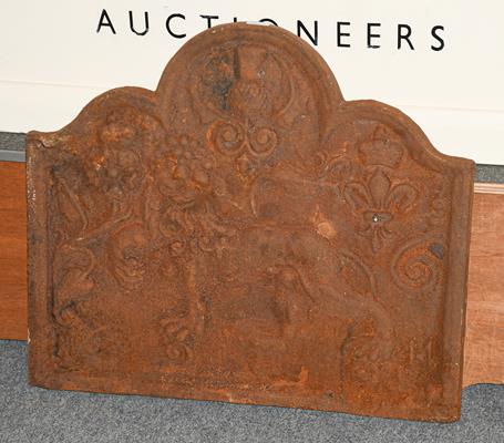 A cast iron metal fire back decorated with a lion and thistle in relief