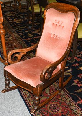 A late Victorian mahogany framed rocking chair with pink buttoned upholstery