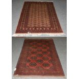 An Afghan Turkman rug, the brick red field with columns of panels enclosed by multiple narrow