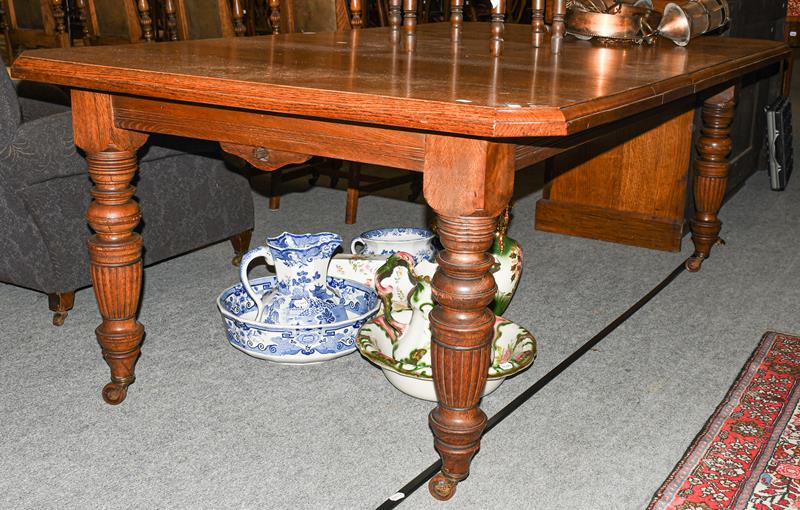 A Victorian oak wind-out dining table with two additional leaves, 243cm (open) by 120cm, 74cm high