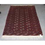 A Tekke rug, the field with three columns of guls enclosed by multiple narrow borders, 148cm by