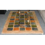 A 20th century wool rug, with green, blue and orange rectangles on an oatmeal ground, labelled RC