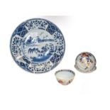 An 18th century Chinese blue and white dish painted with a river landscape, together with an 18th