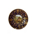 A Derby saucer dish, circa 1800, central painted scene of a view in Switzerland, 21.5cm diameter. No