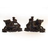 A pair of wooden carved models of water buffalo, 24cm wide