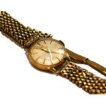 A lady's 9 carat gold wristwatch, signed Omega, with attached 9 carat gold later associated