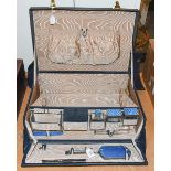 Silver and blue enamel dressing table items, travelling case marked inside ''The Northern Goldsmiths
