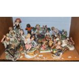 A quantity of Capodimonte coloured bisque and composite figures including signed examples,