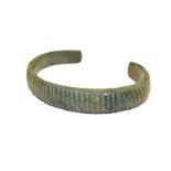 A Roman bronze torque bangle with reeded decoration, 8cm wide