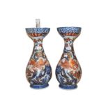 A large pair of Japanese Meiji period baluster formed vases, decorated with exotic birds in