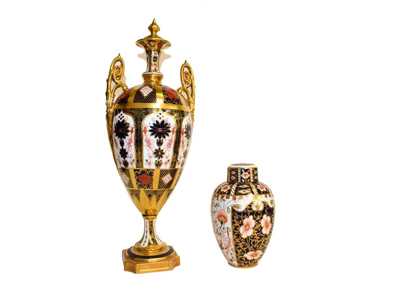 A Royal Crown Derby twin handled vase in Imari pattern (a.f.) and a small vase and cover (2). Larger