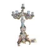 A Meissen porcelain seven light figural candelabrum, late 19th century, with flower encrusted scroll