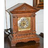 An oak cased mantel clock, eight day Junghans movement, of architectural form with pendulum