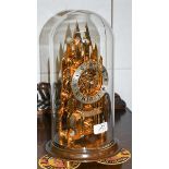 A brass cathedral form skeleton mantel timepiece, signed Elliott, London, beneath glass dome
