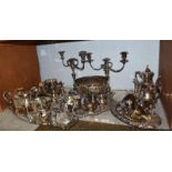 A large quantity of silver plated wares including tea services, a pair of three branch candelabra,