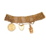 A gate link bracelet, stamped '9' and '.375', hung with a 1914 half sovereign and a further charm,