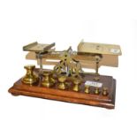 A set of brass letter scales and four cased cutlery sets to include fish knives and forks, fruit