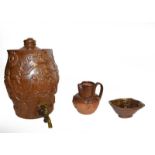 A quantity of brown and salt glazed stoneware including a spirit barrel sprigged with the Royal