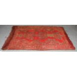 An Ushak Rug, the tomato red field with three medallions enclosed by multiple narrow borders,