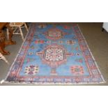 An Isparta rug, the sky blue field with two cruciform medallions enclosed by Kufic borders, 267cm by