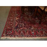 Bakhtitari carpet, the blood red field centered by a flower head medallion framed by spandrels and