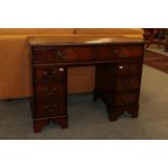 A reproduction mahogany veneered leather inset twin pedestal desk, 107cm by 54cm by 80cm