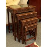 A 20th century Chinese heavily carved nest of four occasional tables, 50cm by 36cm by 65cm