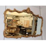 A 20th century Neo-Classical style hall mirror adorned with an urn shaped pediment, 56.5cm by 107cm,