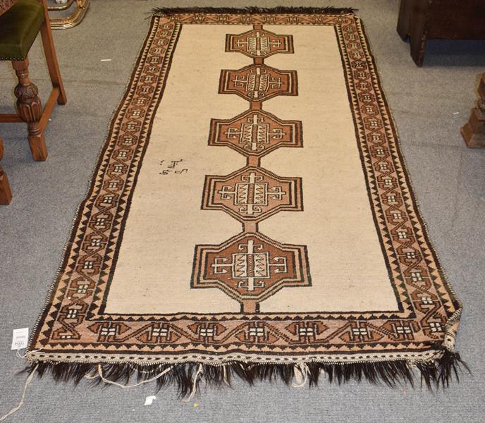 Gabbeh rug, the ivory field with linked medallions, framed by border of geometric motifs, 288cm by