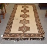 Gabbeh rug, the ivory field with linked medallions, framed by border of geometric motifs, 288cm by