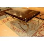 A modern coffee table with simulated rosewood top on a chrome base, 117cm by 71cm by 53cm