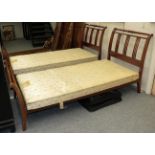 A pair of mahogany single bed frames, with bed bases (2)