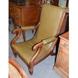 A 19th century mahogany and studded green leather low chair, with padded scroll arms and reeded