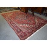 Ahar Heriz carpet, the blood red field with a central flower head medallion framed by spandrels,