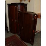 A George III mahogany bow-front wall hanging corner cupboard, with another (2)