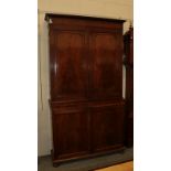 A Georgian mahogany bookcase cabinet, the double cupboard doors opening to reveal a shelved