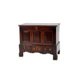 An 18th Century Joined Oak Chest, the moulded lid enclosing a vacant interior above three fielded