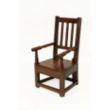 An 18th Century Joined Oak Child's Chair, the reeded splats above turned spindle armrests and