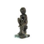 After the Antique: A Bronze Figure of Spinario, sitting on a rocky outcrop and rectangular base,