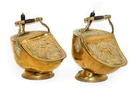 A Pair of Victorian Brass Coal Purdoniums and Shovels, of helmet form, stamped with classical motifs